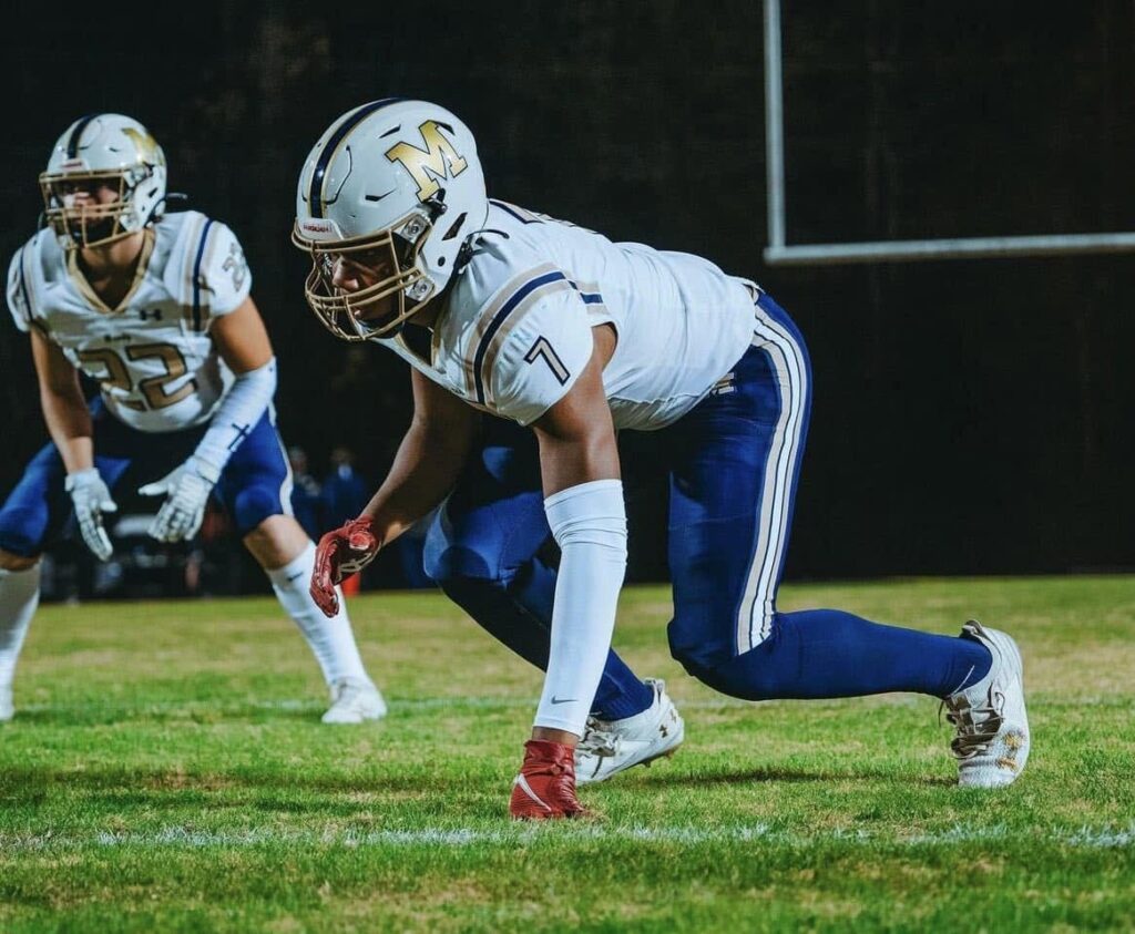 A 2027 Colorado linebacker commit lines up in a three-point stance during his junior high school season.