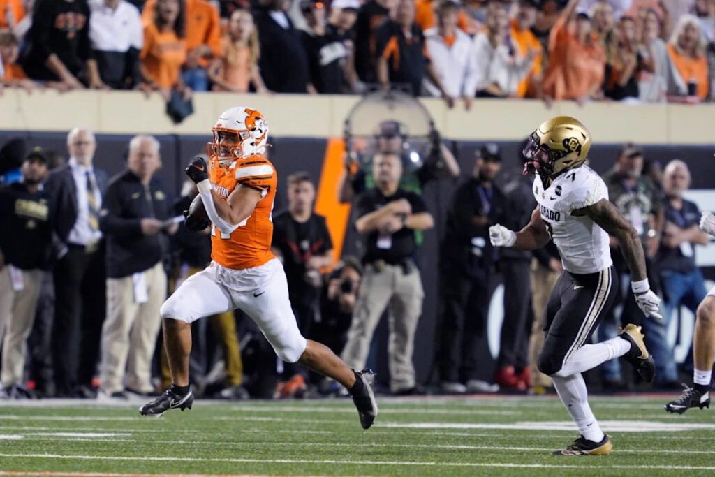 An Oklahoma State player breaks away from a Colorado defender in Stillwater.