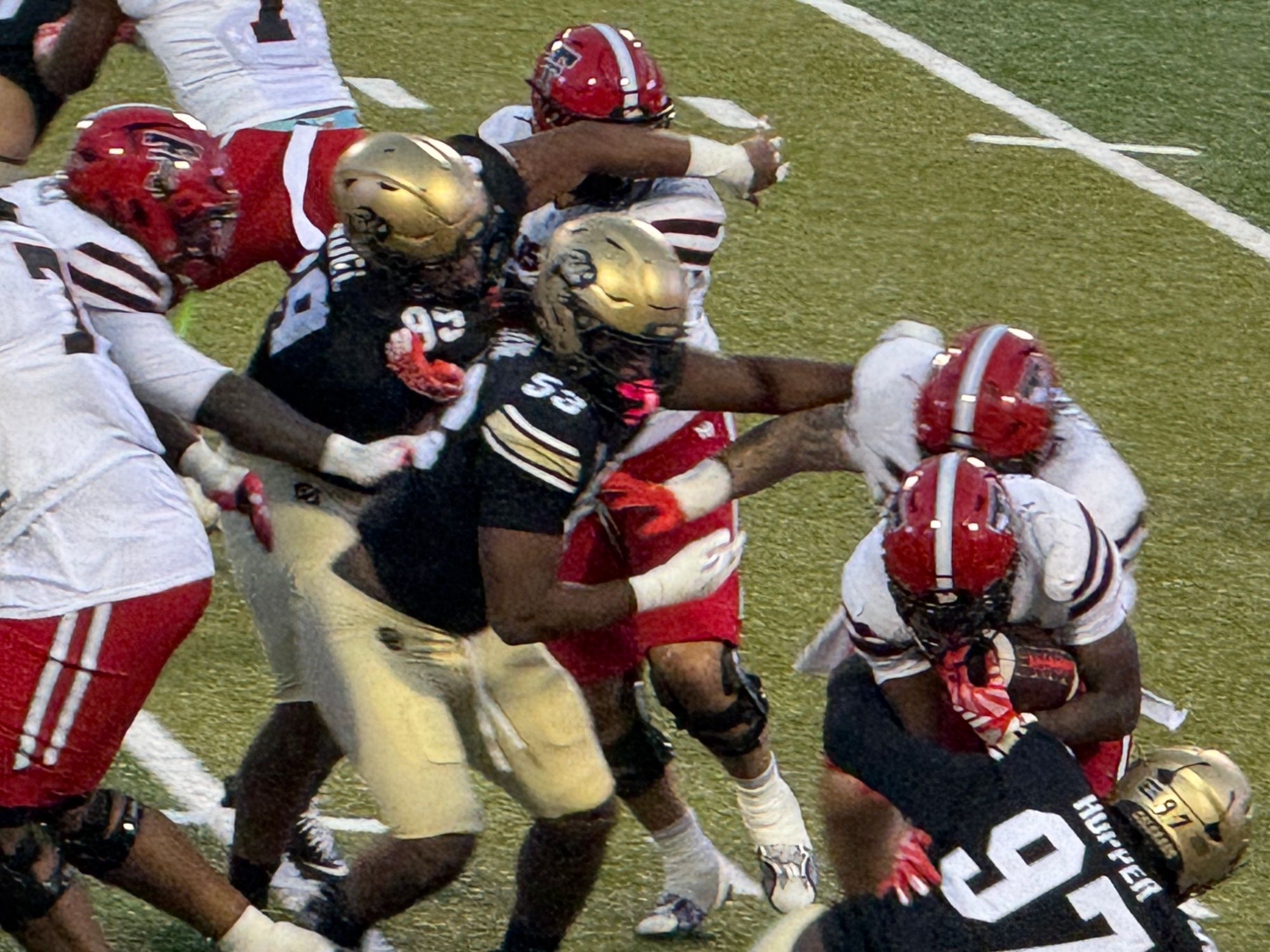 Colorado defensive lineman Santana Hopper, No. 97, working through Texas Tech blockers at the line of scrimmage at Folsom Field.