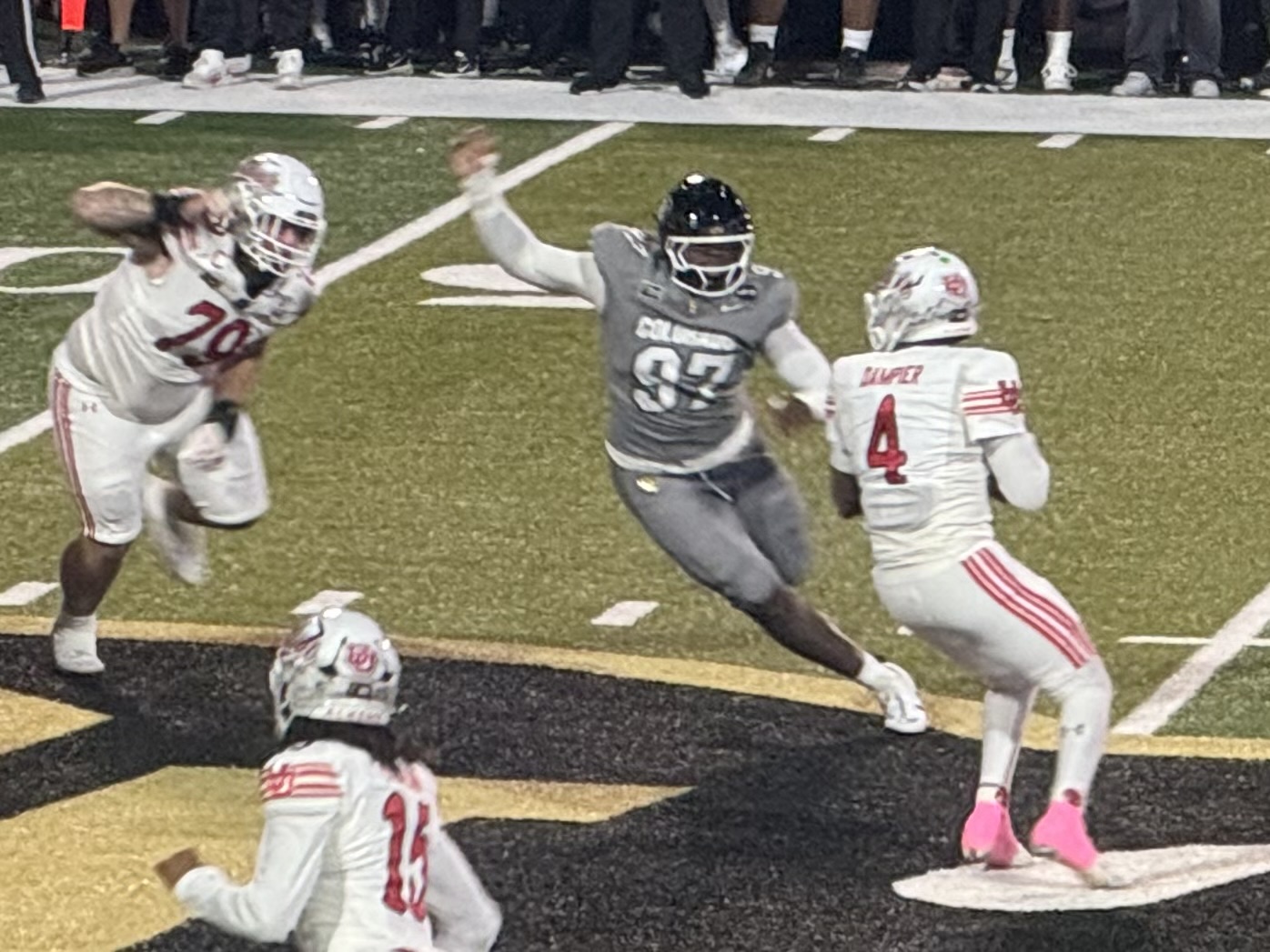 Colorado defensive lineman Santana Hopper closes on Utah quarterback Devon Dampier.